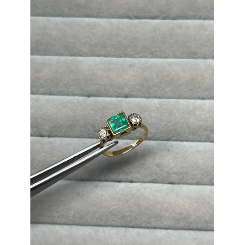 84 - 18ct Yellow and white gold emerald and diamond trilogy ring comprising of a square cut emerald weigh... 