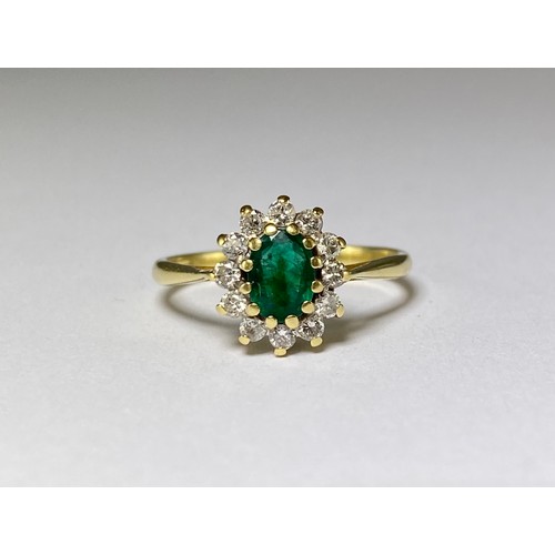 87 - 18ct Yellow Gold Emerald and Diamond cluster ring featuring an oval emerald weighing approximately 0... 