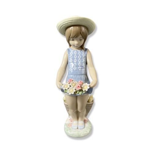 84 - Lladro Signed and dated 1284 Flowers on the lap, comes in box, one petal is slightly damaged