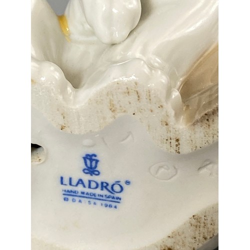 233 - Lladro 5238 Eskimo boy with pet, small chip on collar