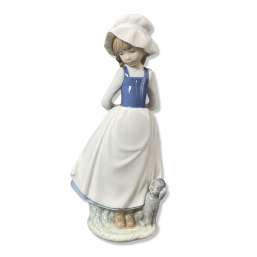 70 - X2 Nao by Lladro to include girl in blue dress with hands behind back and girl with dog both in good... 