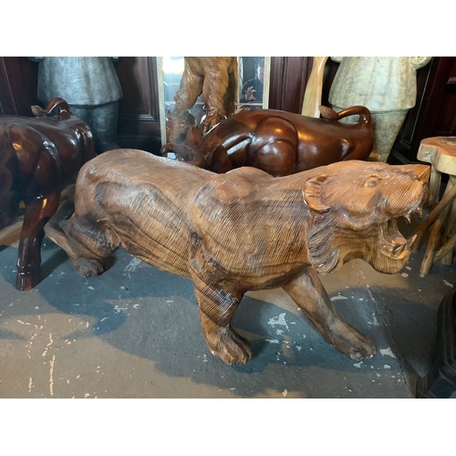 103 - WOODEN SCUPLTURE OF A PROWLING LION APPROX 1M LONG WEIGHING AROUND 40KG