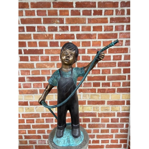 126 - CAST BRONZE FIGURE DEPICTING A BOY HOLDING A HOSE