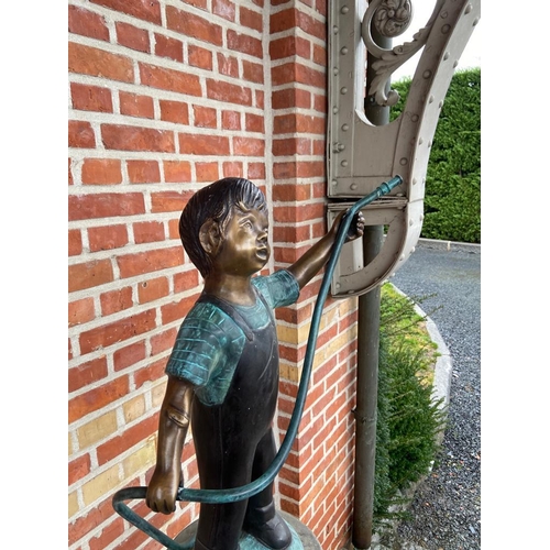 126 - CAST BRONZE FIGURE DEPICTING A BOY HOLDING A HOSE