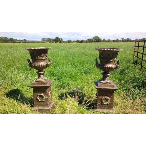 50 - PAIR CAST IRON URNS ON PLINTH IN GREEN BRONZE FINISH