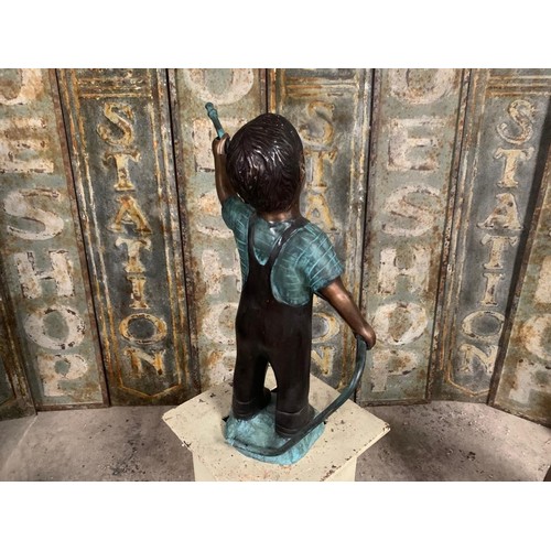 54 - CAST BRONZE FIGURE DEPICTING A BOY HOLDING A HOSE