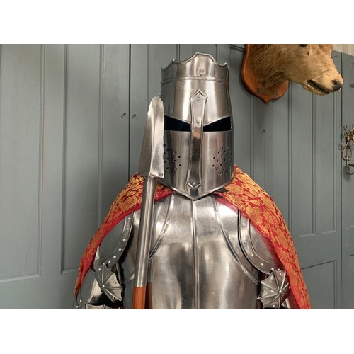 96 - HUGE MEDIEVAL DECORATIVE SUIT OF ARMOUR IN POLISHED STEEL WITH WITH SHIELD IN RED ROBE
