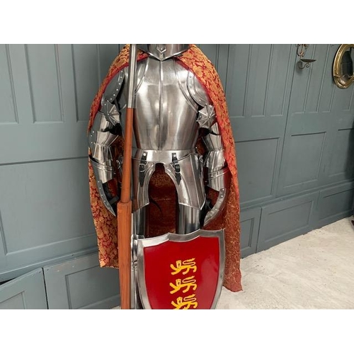 223 - HUGE MEDIEVAL DECORATIVE SUIT OF ARMOUR IN POLISHED STEEL WITH WITH SHIELD IN RED ROBE