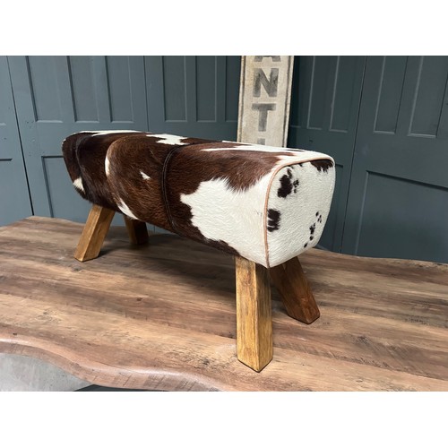 23 - BOXED NEW LARGE BROWN AND WHITE COW HIDE POMMEL HORSE (Due to the nature of the raw cow hide materia... 