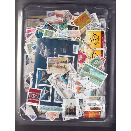 123 - Many 100's of stamps in two containers covering many years selling a kiloware off paper mixture unch... 