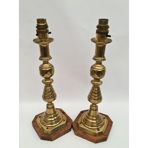 191 - Pair of Victorian Brass Candlesticks Converted to Lamps Mounted on Wooden Plinths. Each Measures 15 ... 