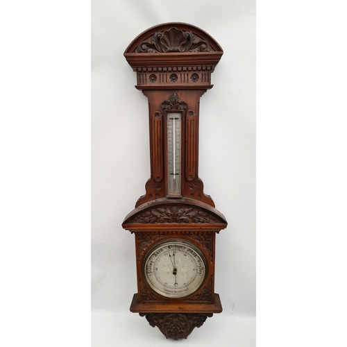 194 - Victorian Large Mahogany Cased Aneroid Barometer. Carved Panels and Pediment. Measures 41 inches by ... 