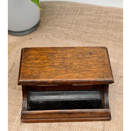 231 - Antique Early 20th Century Oak Inkwell Stand. Has pen rest at the front with lidded compartment for ... 