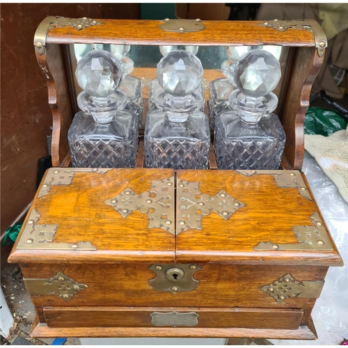34 - Antique Victorian Games Tantalus With Three Cut Glass Decanters. Oak with brass corner fixings and d... 