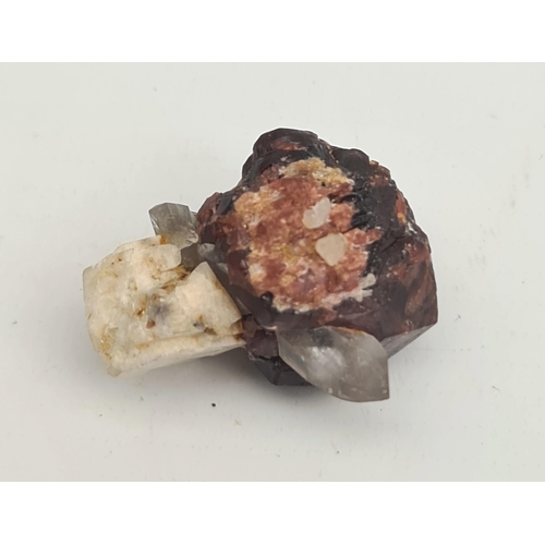 395 - Collectable Mineral Almandine Garnet Weight 22g. Measures 30mm by 28mm by 25mm. Shipping is availabl... 