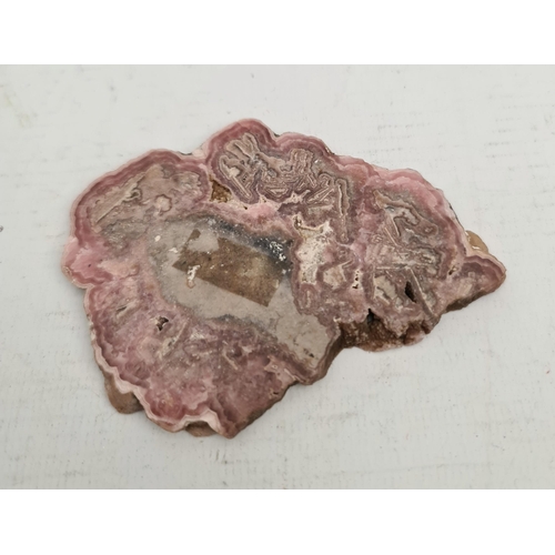 397 - Collectable Mineral Polished Rhodochrosite Slice. Measures 9cm by 7cm. Total weight 65g. Shipping is... 