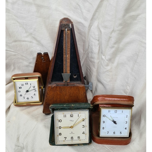 4 - Vintage Metronome and Three Cased Travel Clocks. Shipping is available. Please ask for a quote befor... 