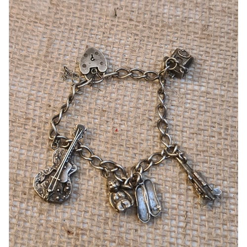 59 - Jewellery Sterling Silver Charm Bracelet With Five Silver Charms. Includes Space Rocket, Guitar, Mon... 