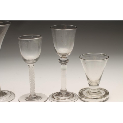 108 - A COLLECTION OF FIVE WINE GLASSES, mainly Georgian, comprising a round funnel bowl on a double serie... 