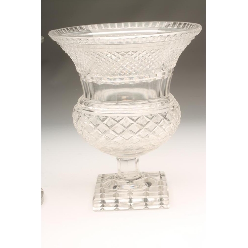 110 - A GLASS CAMPANA URN with diamond and strawberry cut bands raised upon a hexagonal low stem and squar... 