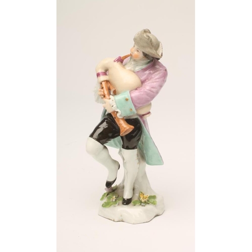 41 - A SAMSON PORCELAIN FIGURE, late 19th century, of a young male bagpipe player wearing a grey hat and ... 