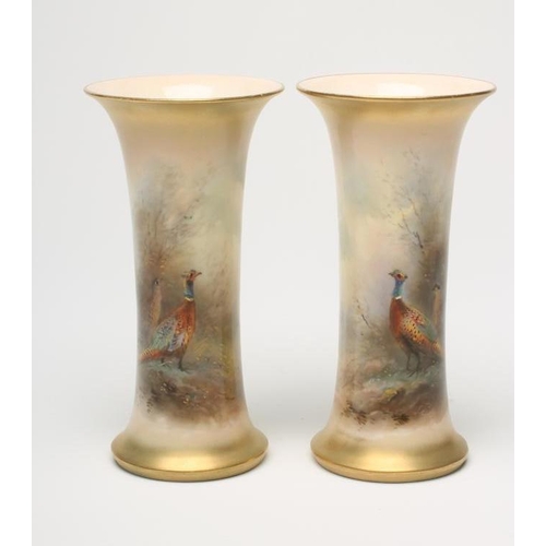 59 - A PAIR OF ROYAL WORCESTER CHINA VASES, 1921, of waisted cylindrical form painted in polychrome ename... 