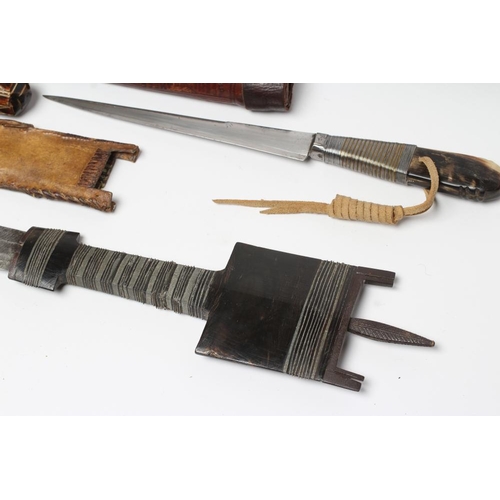 367 - FOUR AFRICAN EDGED WEAPONS comprising two Bou Saa'da daggers with highly decorative wire wound grips... 