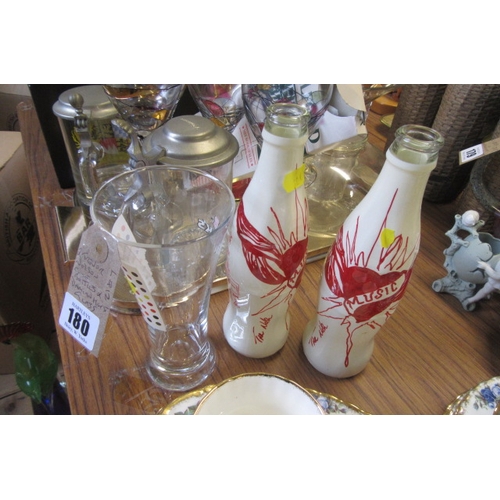 180 - TWO TREVOR NELSON COKE BOTTLES AND A DAMIEN HIRST GLASS