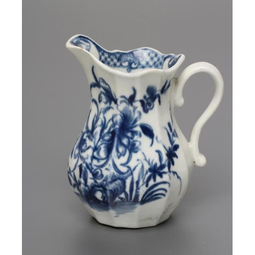 34 - A FIRST PERIOD WORCESTER PORCELAIN MILK JUG, c.1760, of faceted baluster form painted in underglaze ... 