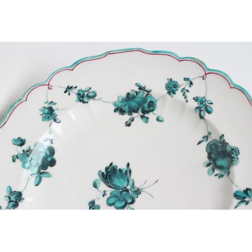 41 - A CHELSEA PORCELAIN PLATE, c.1755, of fluted circular form, painted en camaieu green in the atelier ... 