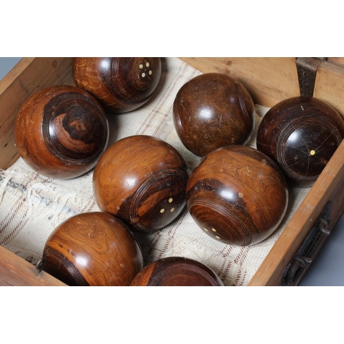 461 - A SET OF EIGHT LIGNUM VITAE LAWN BOWLING BALLS together with a pair of Jacks, the latter inscribed 