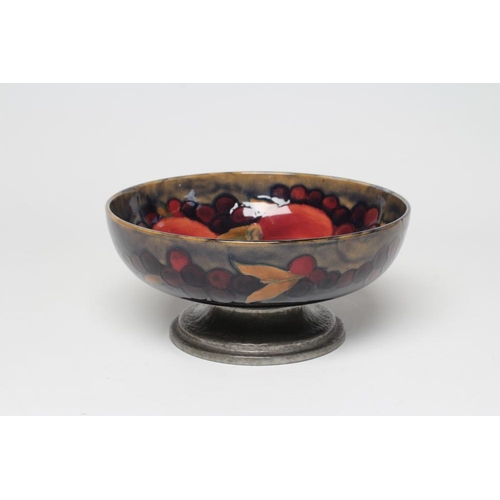 51 - A MOORCROFT POTTERY BOWL, early 20th century, of shallow plain circular form, tubelined and painted ... 