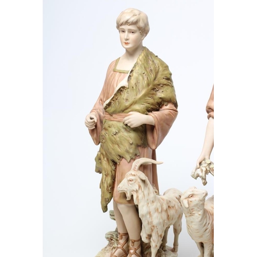 54 - A LARGE PAIR OF ROYAL DUX BISQUE PORCELAIN FIGURES, early 20th century, modelled as a young goatherd... 