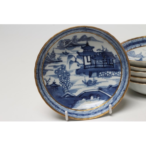6 - A SET OF SIX CHINESE PORCELAIN RIBBED TEABOWLS AND SAUCERS painted in underglaze blue with a landsca... 