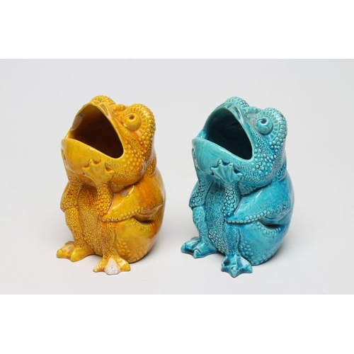 63 - TWO BURMANTOFTS POTTERY TOAD SPOON WARMERS, seated holding their heads in their hands, one turquoise... 