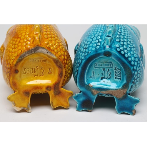 63 - TWO BURMANTOFTS POTTERY TOAD SPOON WARMERS, seated holding their heads in their hands, one turquoise... 