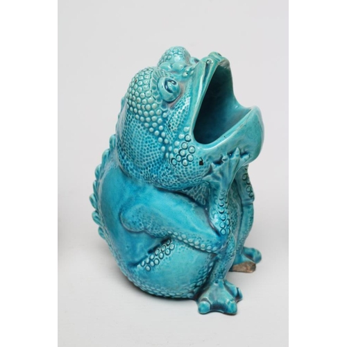 63 - TWO BURMANTOFTS POTTERY TOAD SPOON WARMERS, seated holding their heads in their hands, one turquoise... 