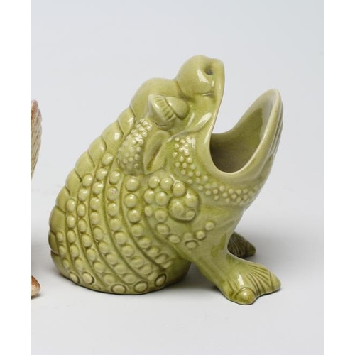 65 - TWO BURMANTOFTS POTTERY SPOON WARMERS, both green glazed and modelled seated, comprising toad, model... 