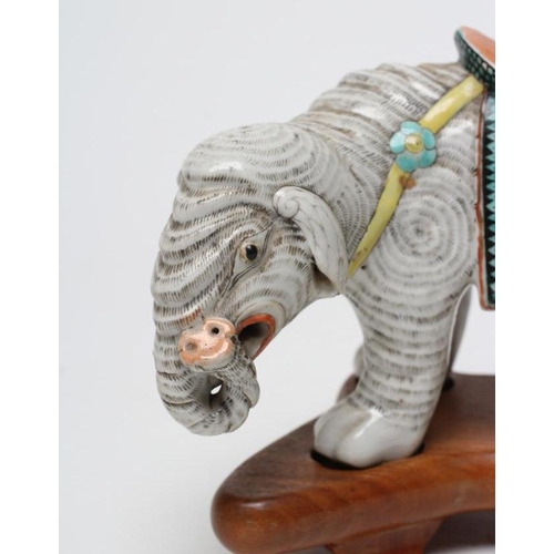 7 - A CHINESE PORCELAIN JOSS STICK HOLDER/INCENSE BURNER modelled as an elephant with orange, green and ... 