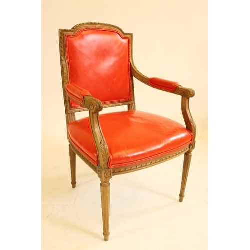 749 - A LOUIS XVI STYLE BEECH ELBOW CHAIR, c.1900, upholstered in red leather, the channelled frame with a... 