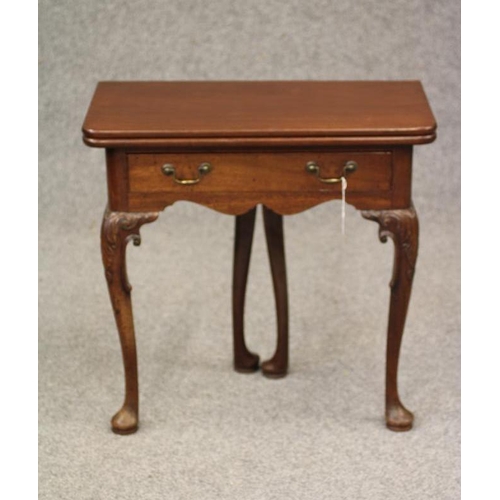 750 - A GEORGIAN MAHOGANY FOLDING TEA TABLE, mid 18th century, of rounded oblong form with centre folding ... 