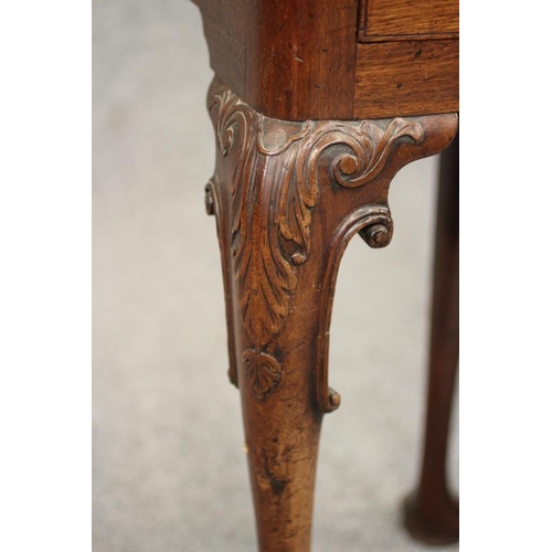 750 - A GEORGIAN MAHOGANY FOLDING TEA TABLE, mid 18th century, of rounded oblong form with centre folding ... 