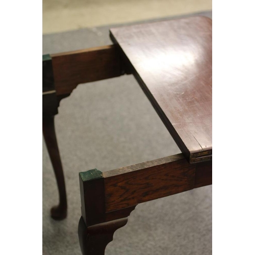 750 - A GEORGIAN MAHOGANY FOLDING TEA TABLE, mid 18th century, of rounded oblong form with centre folding ... 