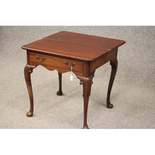 750 - A GEORGIAN MAHOGANY FOLDING TEA TABLE, mid 18th century, of rounded oblong form with centre folding ... 