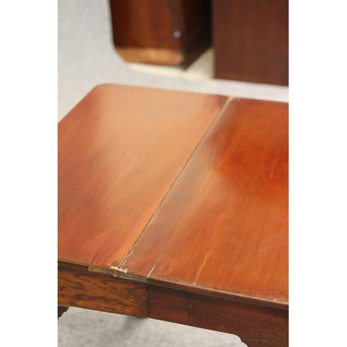 750 - A GEORGIAN MAHOGANY FOLDING TEA TABLE, mid 18th century, of rounded oblong form with centre folding ... 