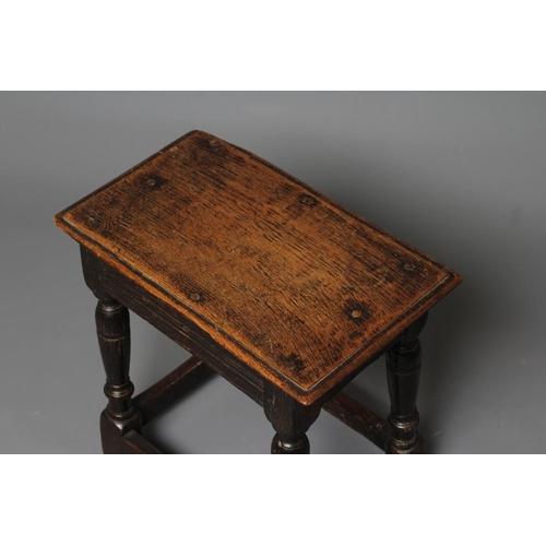 751 - AN OAK JOINED STOOL, late 17th century and later, the ovolo moulded plank seat and moulded frieze ra... 