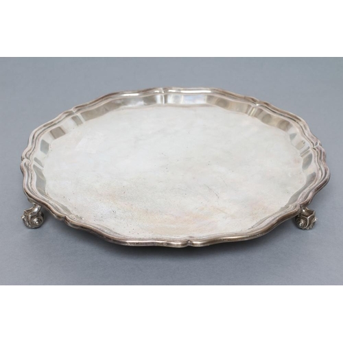 103 - A SALVER, maker Harrods, Sheffield 1934, of shaped circular form with plain pie-crust rim, raised up... 