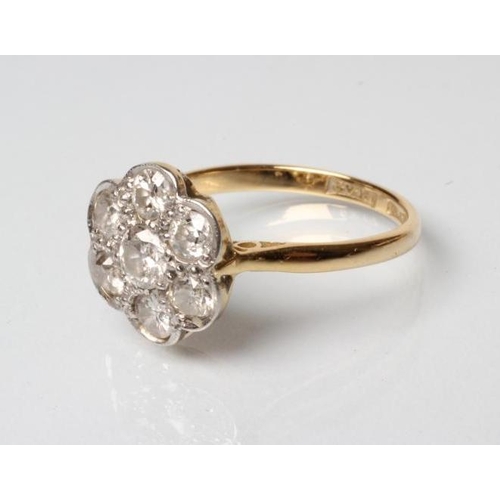 161 - A SEVEN STONE DIAMOND CLUSTER RING, the old brilliant cut stones each of approximately 0.10cts pave ... 