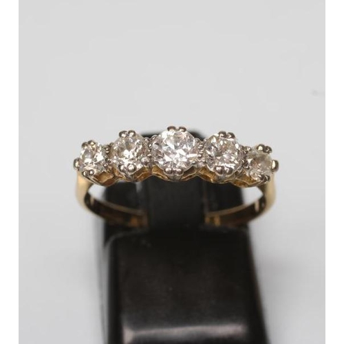 168 - A FIVE STONE DIAMOND RING, the graduated brilliant cut stones claw set to a plain shank stamped 18ct... 