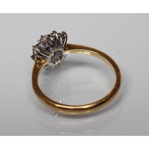 175 - A SAPPHIRE AND DIAMOND CLUSTER RING, the square cut sapphire claw set to a border of ten small round... 